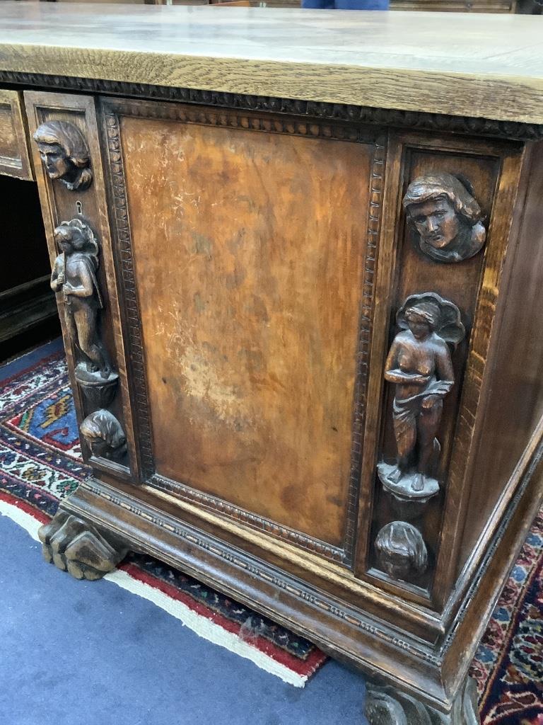 A large late 19th century oak and walnut kneehole desk, width 180cm depth 91cm height 78cm